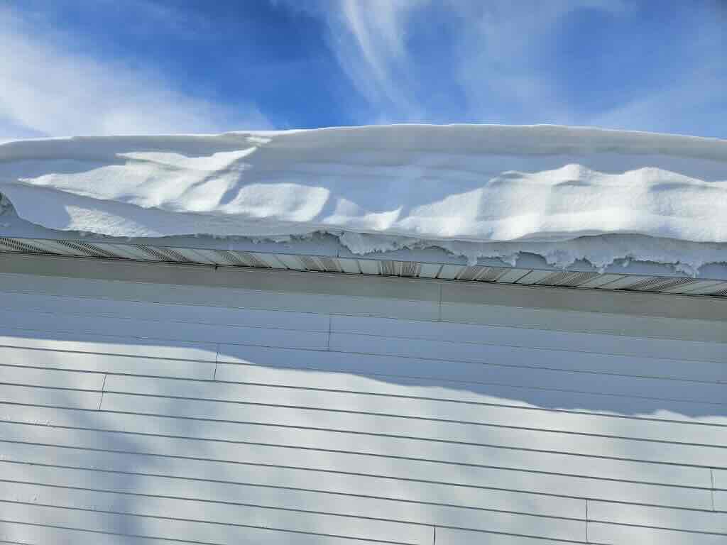 Heavy snow sitting on top of a roof in Rock County, Wisconsin